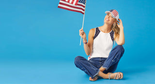 Model wearing Americana outfit. Blue jeans with stars and star printed tank top. 