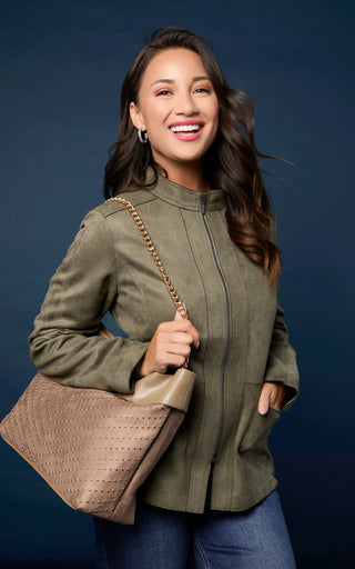 Model wearing blue wide leg jeans and olive zip up jacket.