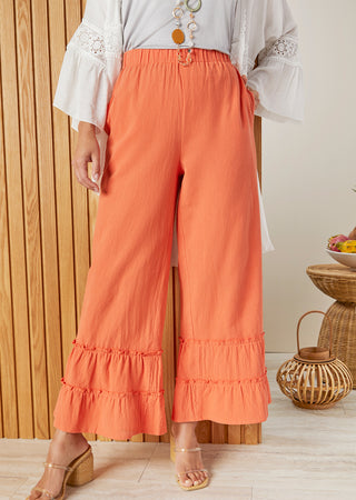 Model wearing orange summer pants.