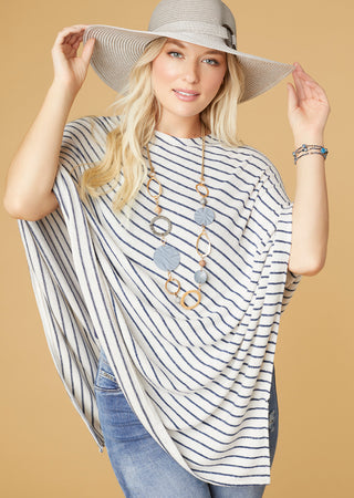 Model wearing blue and white stripe poncho.