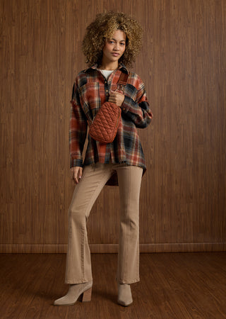 Model wearing fall outfit on wood textured background.