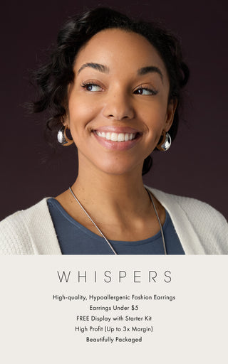 Modeling wearing silver earrings on dark background. Whispers hypoallergenic earring collection.