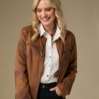 Woman wearing a brown jacket over a white shirt on a beige background
