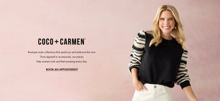 Model  wearing black long sleeve top with stripes on pink background.