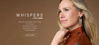 Model close-up wearing mixed metal dangle earrings on a tan background featuring 'WHISPERS' fashion earring collection.