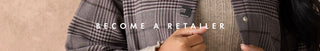 A close-up of a person wearing a gray and black plaid blazer over a beige knit sweater, with the text 'BECOME A RETAILER' overlaid across the center.