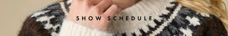 A close-up of a person wearing a fuzzy knit sweater with a dark brown, black, and white geometric pattern, with a hand adjusting the collar. The text 'SHOW SCHEDULE' is overlaid across the center.