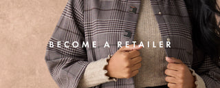 A person wearing a gray and black plaid button-up jacket over a beige ribbed sweater, with the text 'BECOME A RETAILER' overlaid across the center.
