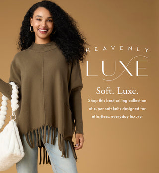 Model wearing an olive sweater with fringe with 'HEAVENLY LUXE' branded copy