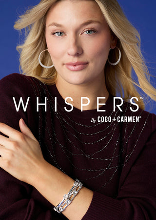 Model wearing burgundy shirt and silver hoop earrings on a bright blue background.