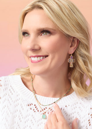 Shop jewelry. Model showcasing earrings and necklace.