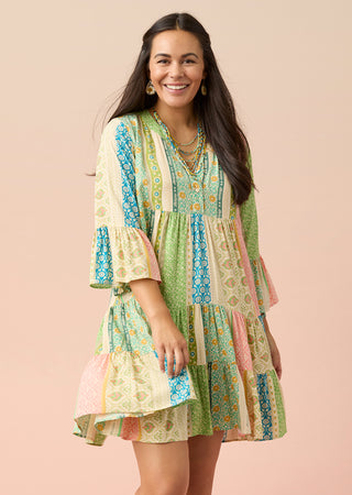 Shop dresses. Model wearing multicolored summer dress.