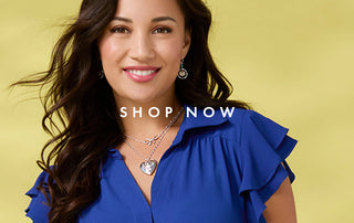 Woman wearing a blue top and necklace with 'Shop Now' text on a yellow background
