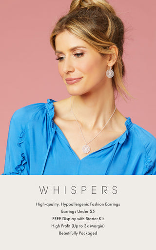 Model wearing bright blue summer top and matching Whispers earring and necklace set.