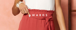Close up of a model wearing terra cotta pants with elastic tie waistband