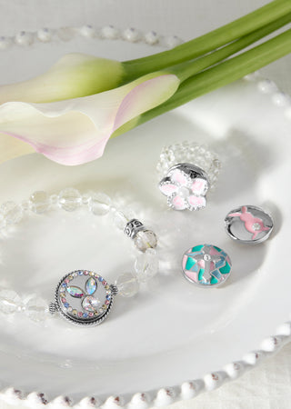 Silver jewelry set with floral elements on a white surface