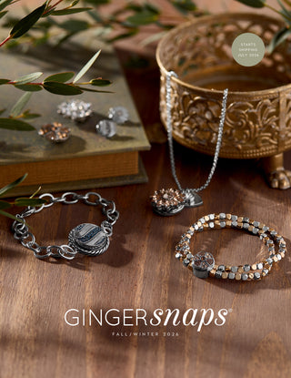 Jewelry set including bracelets and necklaces on a wooden surface with 'Gingersnaps' branding.