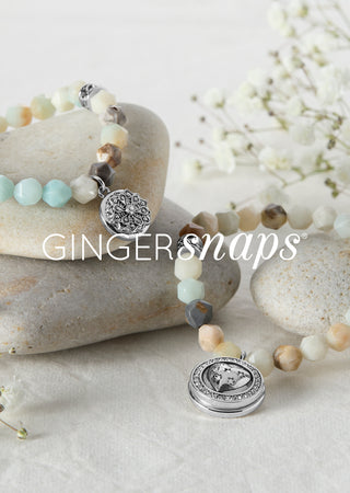 Multicolor bracelets on white background with rocks and flowers promoting 'GINGER SNAPS' collection